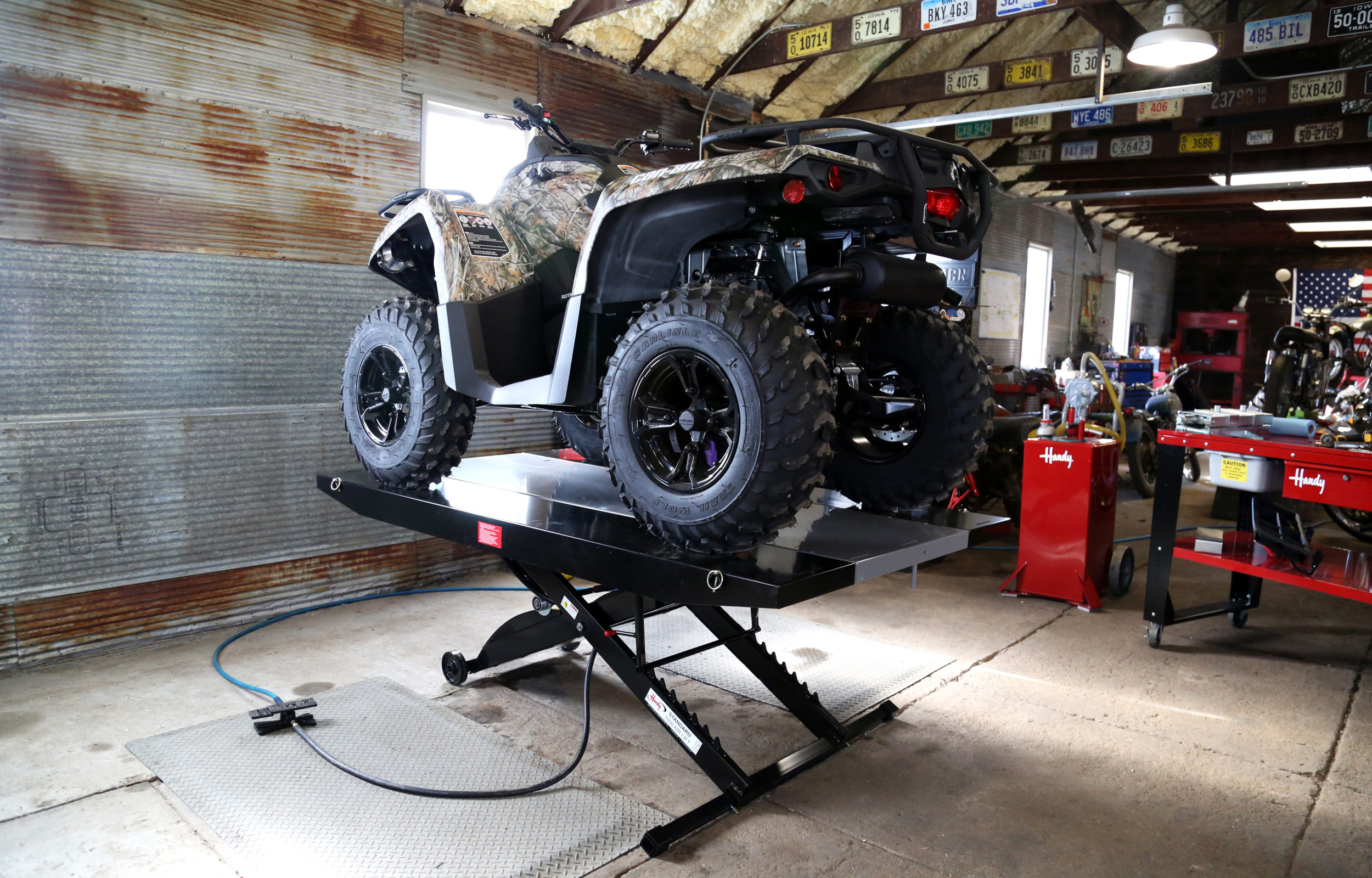 garage with utv on lift with side extenstions